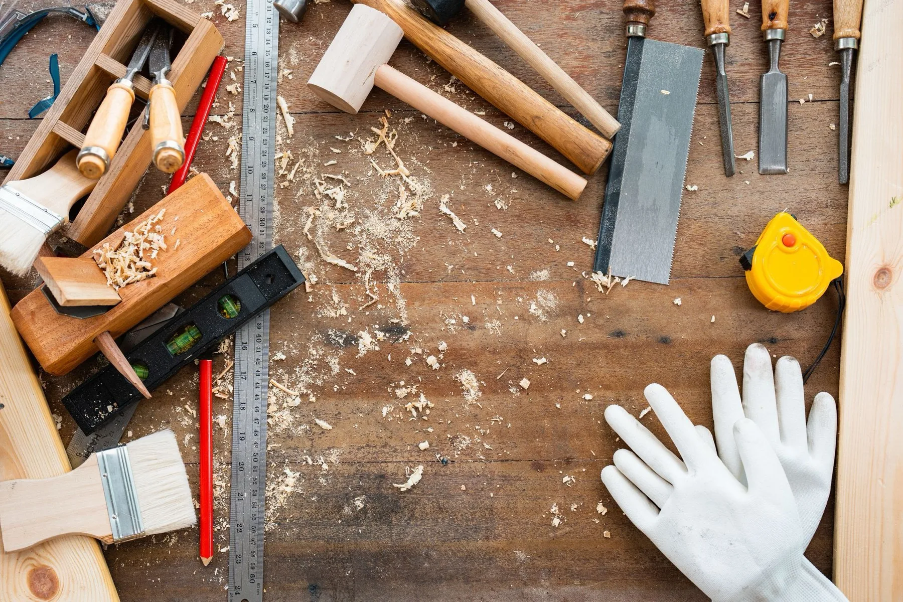Hand tools and wood shavings on a workbench