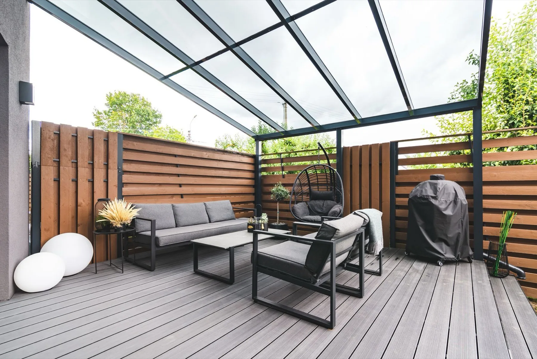 A wood deck with seating around a fire pit