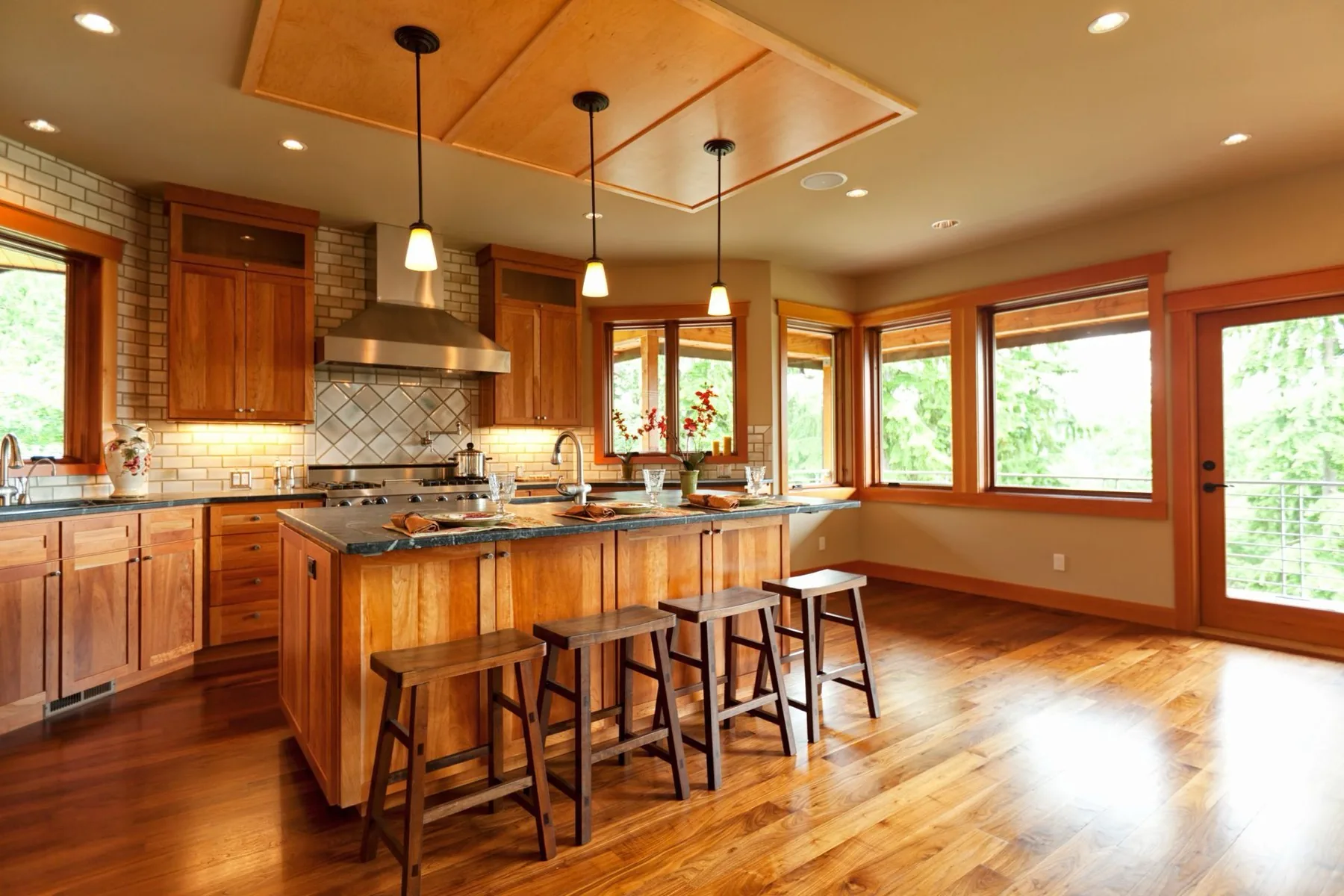 A warm wood kitchen with an island and pendant lighting